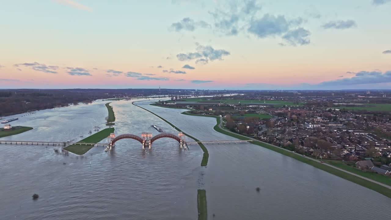 Aerial drone shot of the weir of Driel with the town of Driel on the right side of the frame