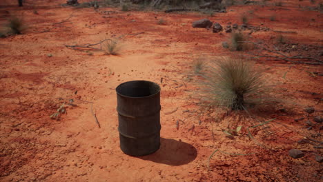 old empty rusted barrel on sand