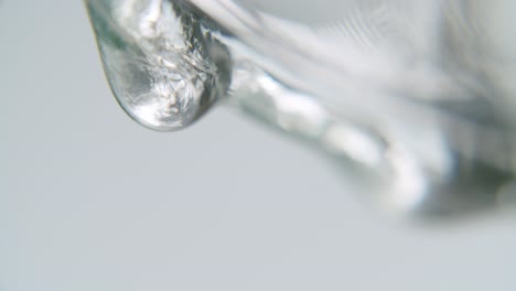 white transparent fluid forming slowly a drop