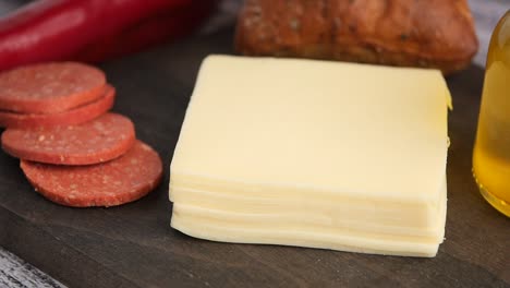 preparing a sandwich with cheese and deli meat