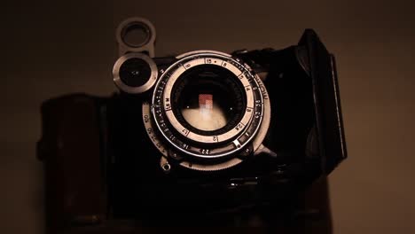 close up of the folding vintage photo film camera in the dark