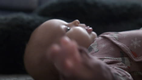 baby girl lying and turning on floor, motor skill natural development