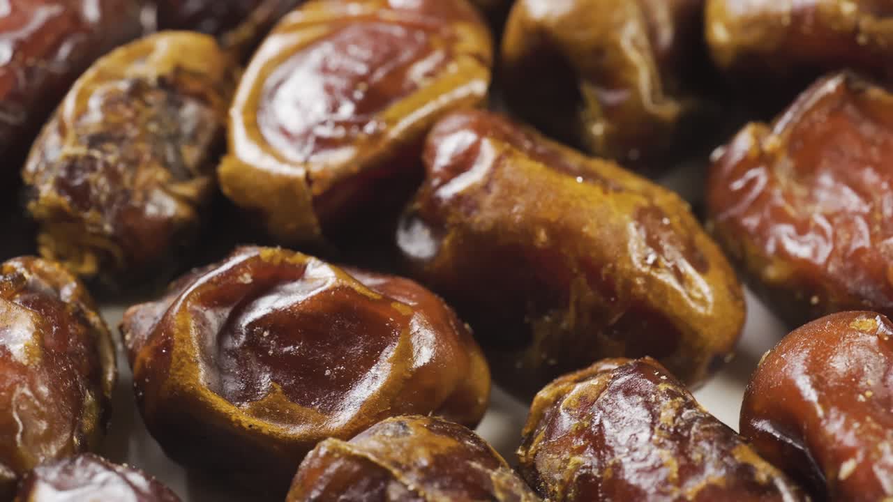 Dried date palm on a rotating table. Snack food macro shot. Slowly spin around in pattern.