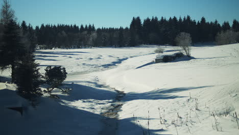 picturesque winter landscape of snowy countryside with background nordic skiers