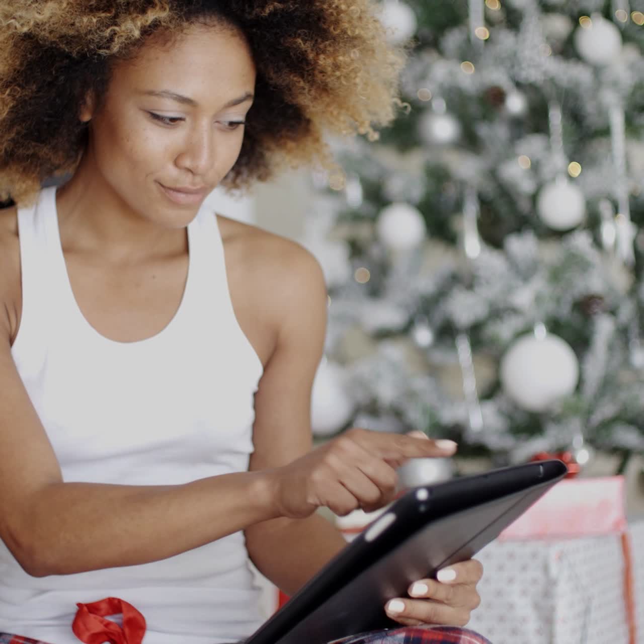 Thoughtful woman catching up on Christmas news