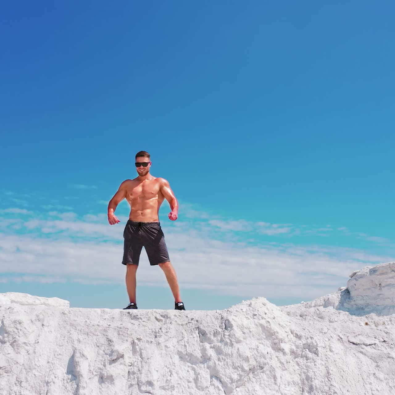 Sporty man posing on mountain