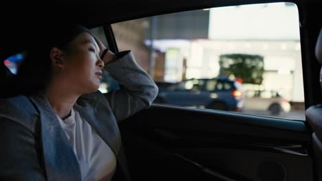 business chinese woman driving in a taxi at night