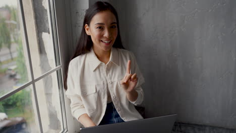 female influencer broadcasting in streaming, she says goodbye waving hand