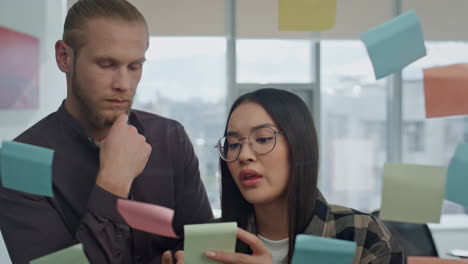 Worried-couple-looking-stickers-hipster-office-portrait.-Freelancers-discussing