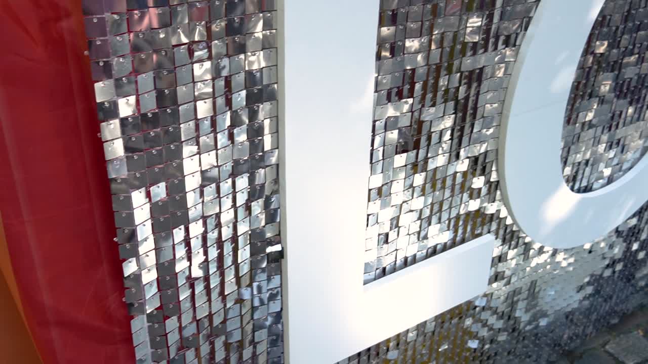 Shiny Love sign and rainbow flag decorating pride festival outdoors