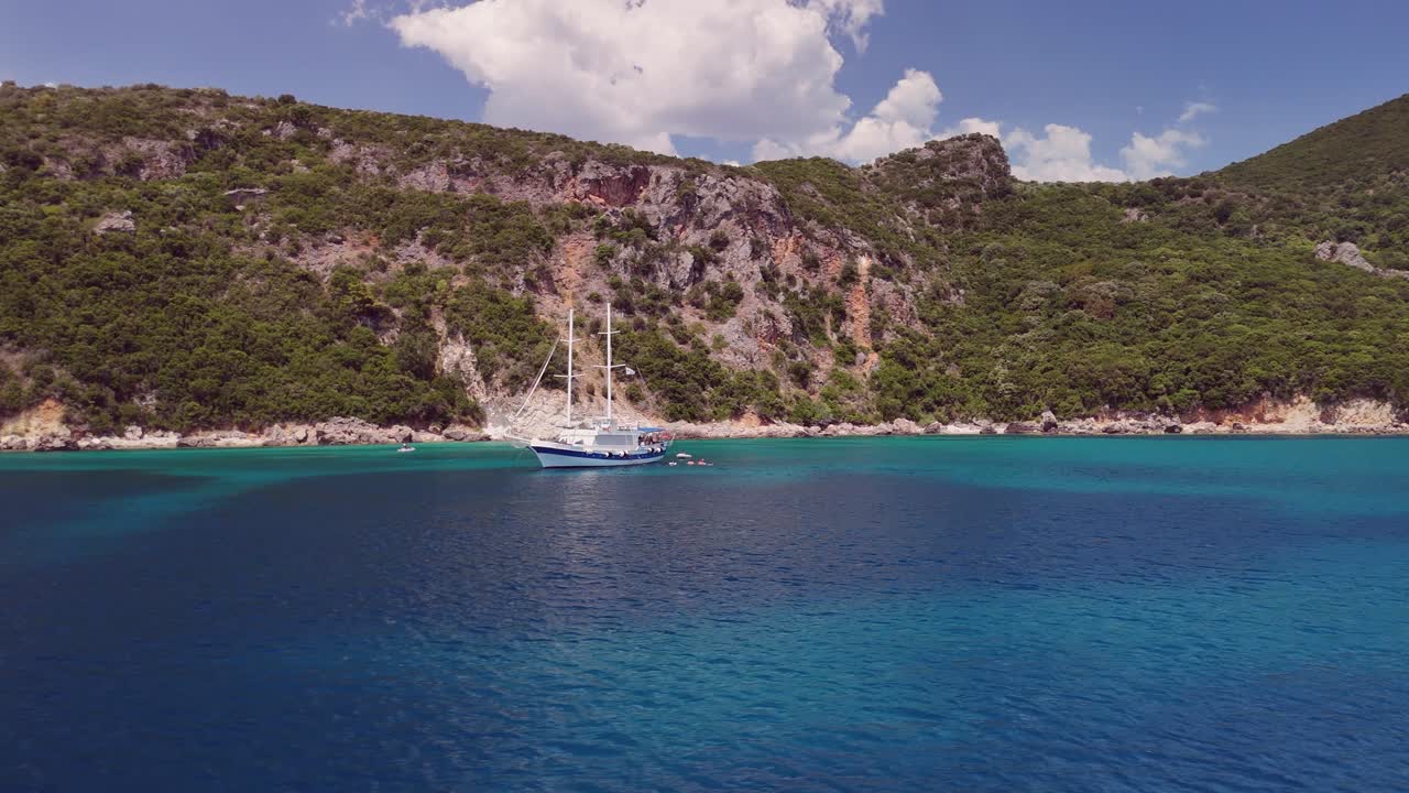 Low Ionian Sea flyby of tourists swimming by tour boat in Greece