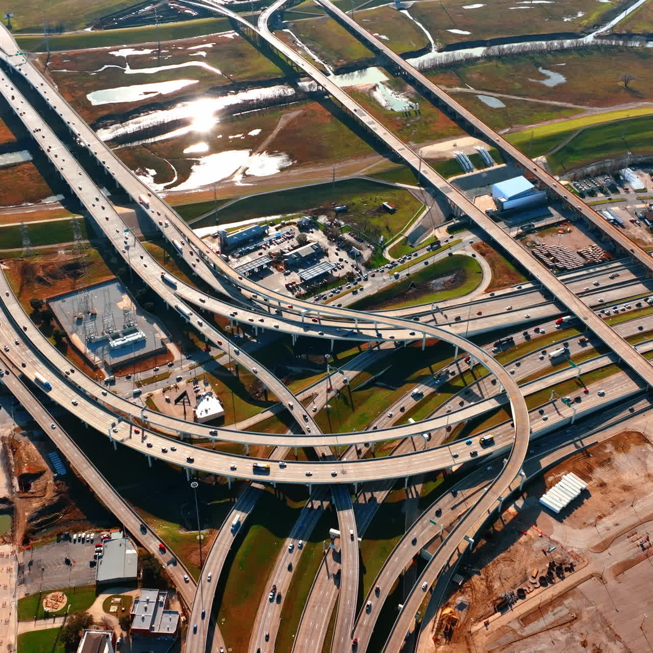 Multiple roads cross and intertwine in the urban landscape. Drone descending above the traffic of Dallas, Texas, USA