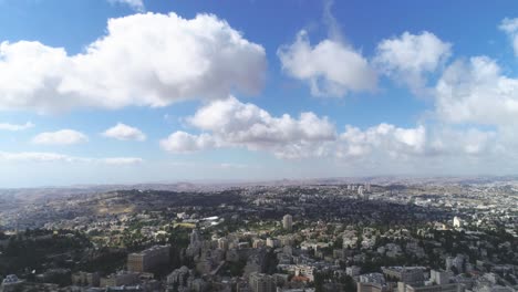 aerial fly over jerusalem with villages and settlements view. showing the wonder of co-existing living in cityscape with famous landmark against blue sky