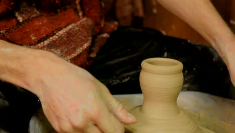 professional male potter working in workshop, studio