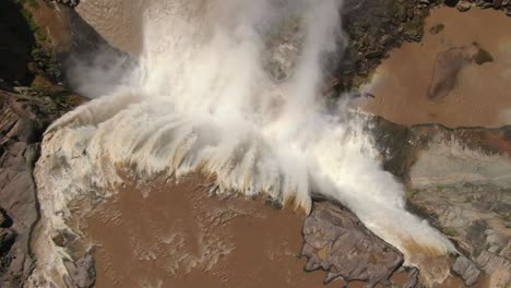 Dramatic-aerial-overhead-view-of-powerful-waterfall,-acrophobia-concept