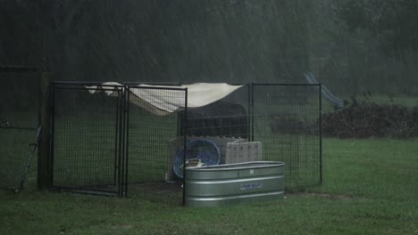 tarp and other objects blow around in the wind during a hurricane, with heavy rain in the country