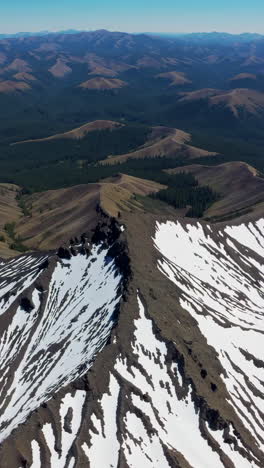 aerial view of mountainous landscape with snow