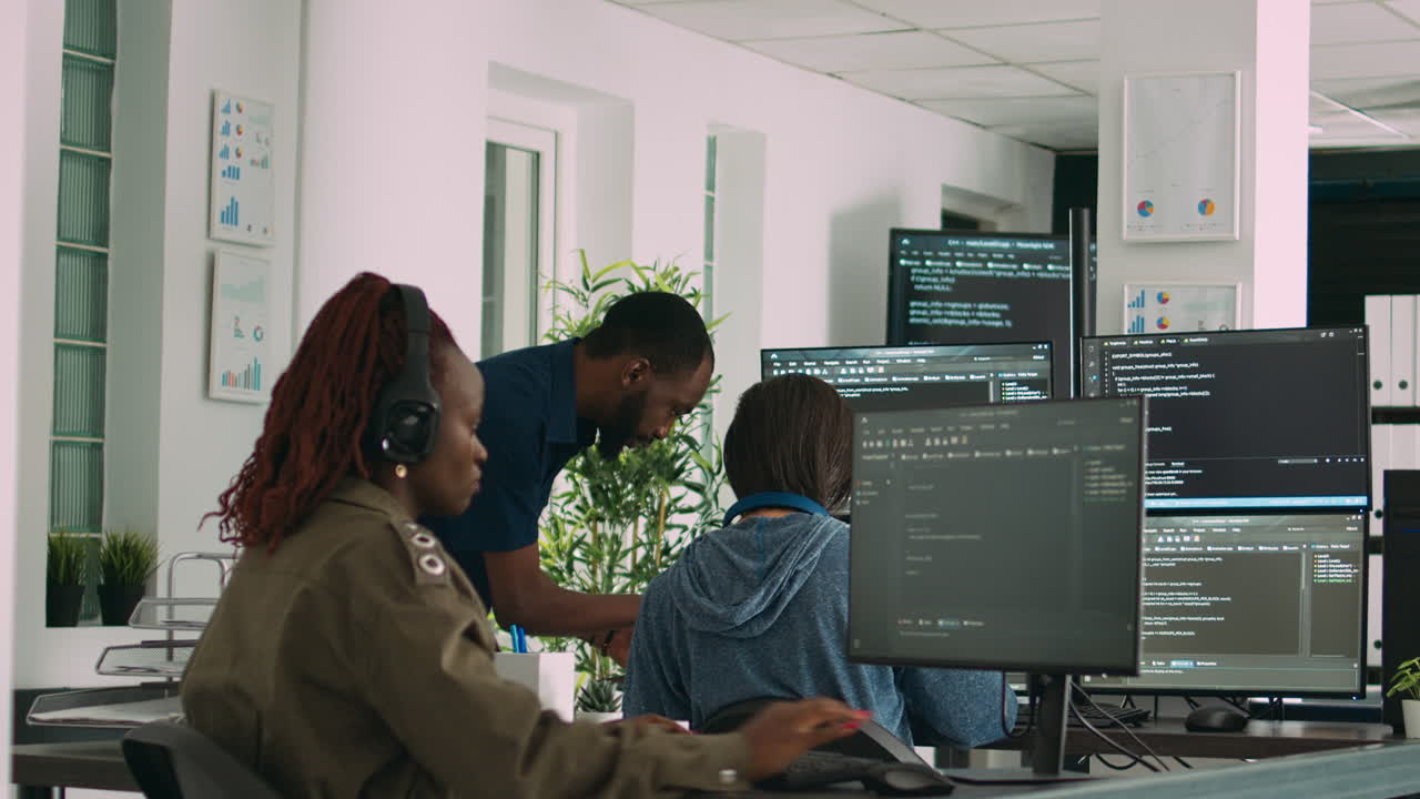 African american focused software engineer working on computer screen