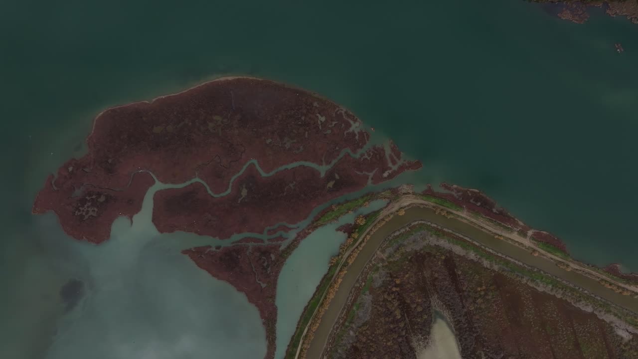 Drone perspective of a pristine lake glowing under the sunlight