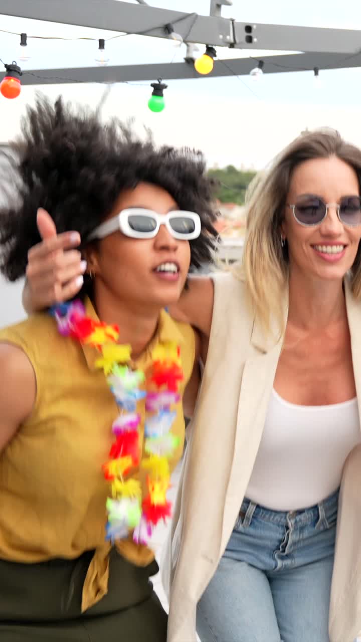Group of friends partying and singing karaoke on a rooftop