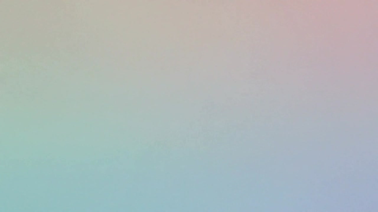 Shifting abstract pastel gradient showing transition from pink and mint to blue-cyan across frame