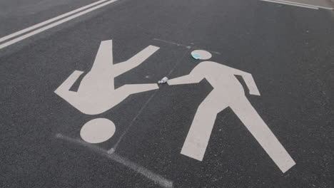discarded face mask on a pedestrian crossing in a park