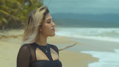 close up of a girl smiling and walking in the sand with her hair blowing in the wind