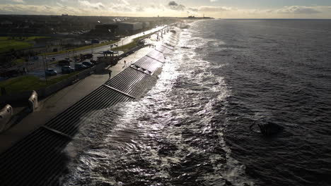 slow motion waves crashing against sea defences on bright day in winter at cleveleys