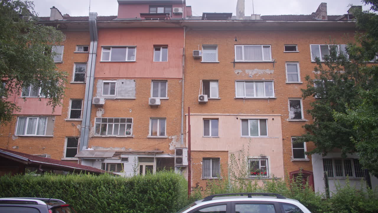 A neighborhood with communist architecture apartment buildings and the surrounding neighborhood environment, parks and trees from the communist era on the Balkans in Sofia, Bulgaria, Eastern Europe