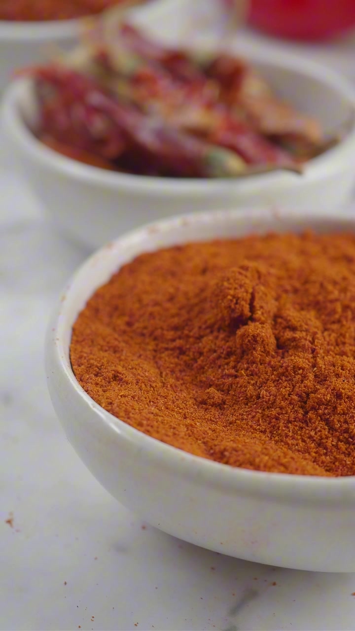 Vibrant Red Chili Powder in a White Bowl