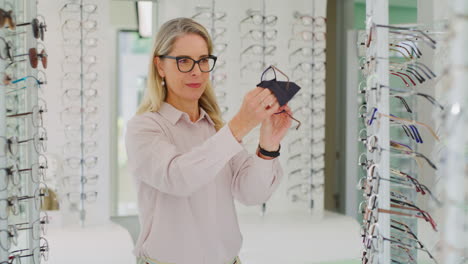 caucasian female optometrist cleaning glasses