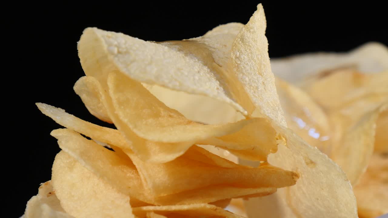 Turning a pile of potato chips on rolling down honey