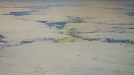 white clouds landscape from above and multicolor water green and blue like outer space planet