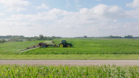 Aerial,-Tractor-Spraying-Pesticides-on-Agricultural-Land-with-Boom-Attachment