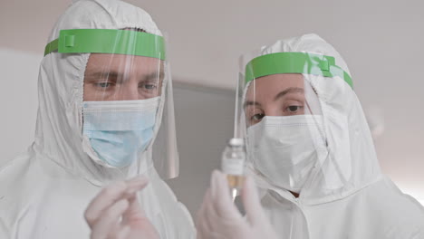 doctors looking at medicine bottle