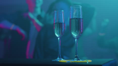 Champagne-glasses-in-the-disco