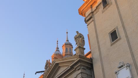 torres y esculturas de la catedral-basílica de nuestra señora del pilar a la hora dorada en zaragoza, españa