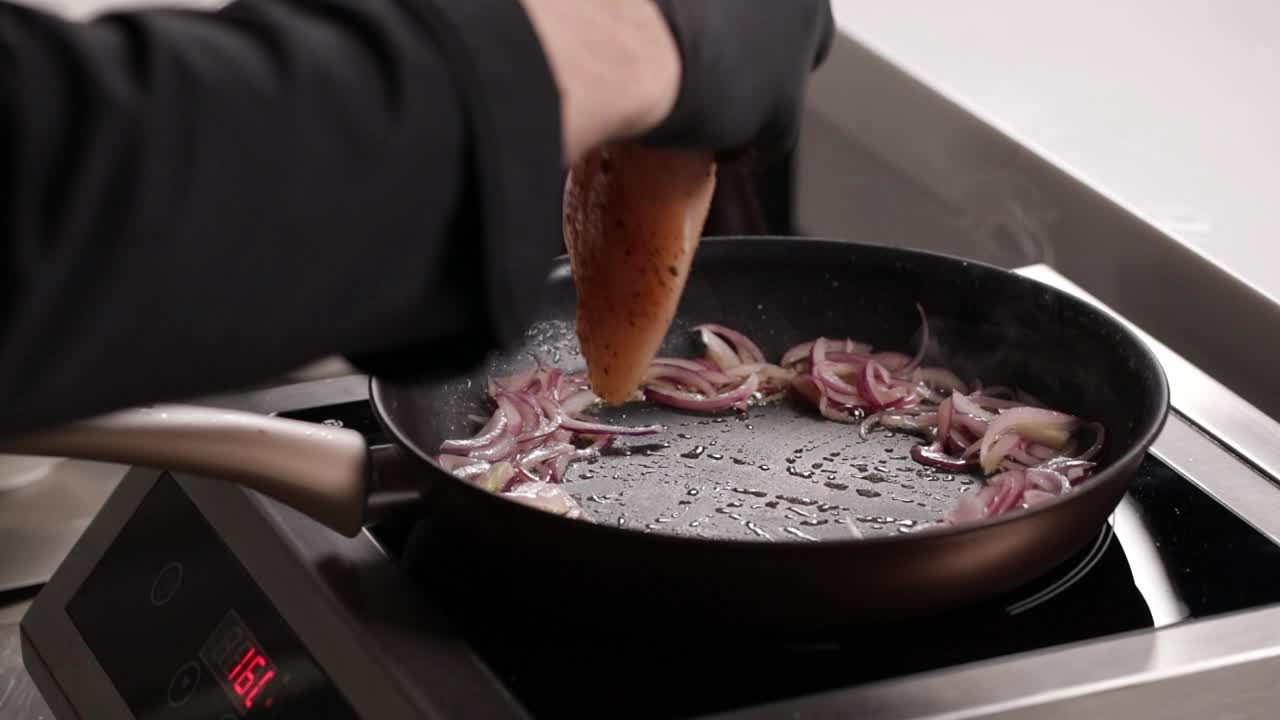 Chef Cooking Chicken Breast with Onions