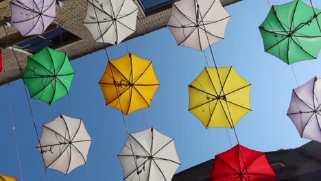 worm's eye orbital view of colorful umbrellas on anne's lane, dublin, ireland