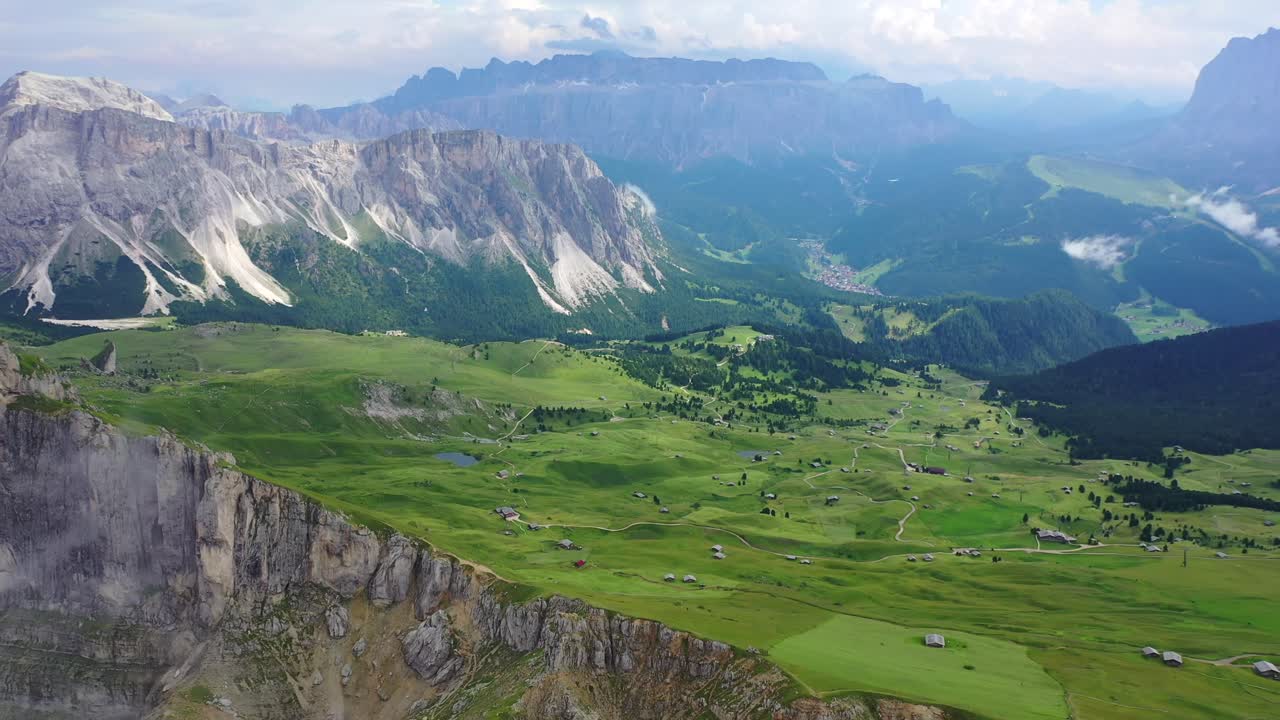 Seceda mountain and Val Gardena valley in summer, pull back aerial