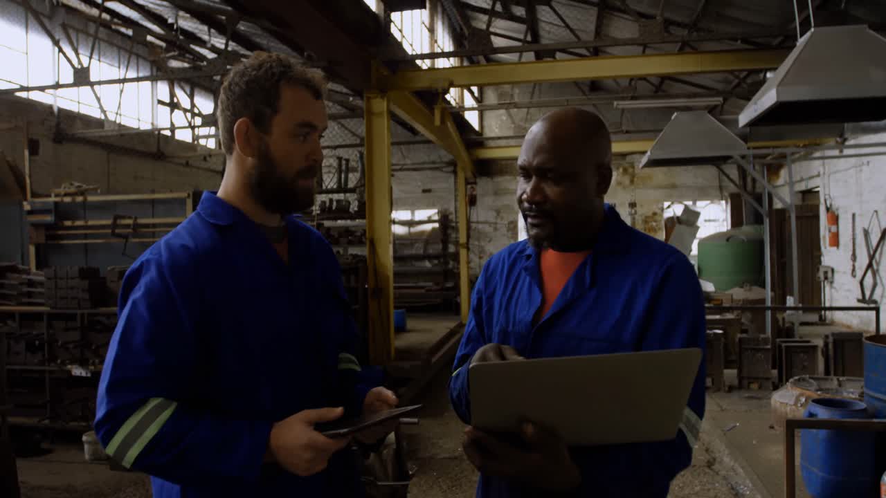 Two metalsmiths discussing over laptop 4k