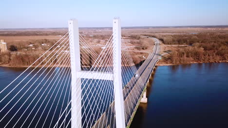 aerial of a suspension bridge crossing the mississippi river near burlington iowa suggests american infrastructure