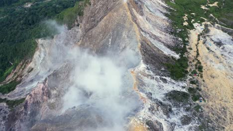 Fly over aerial shot of steam coming from the stratovolcano Mount Sibayak in North Sumatra, Indonesia