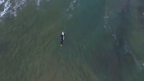 Cinematic-aerial-at-sunrise-of-surfers-along-coast-of-South-Africa-sport