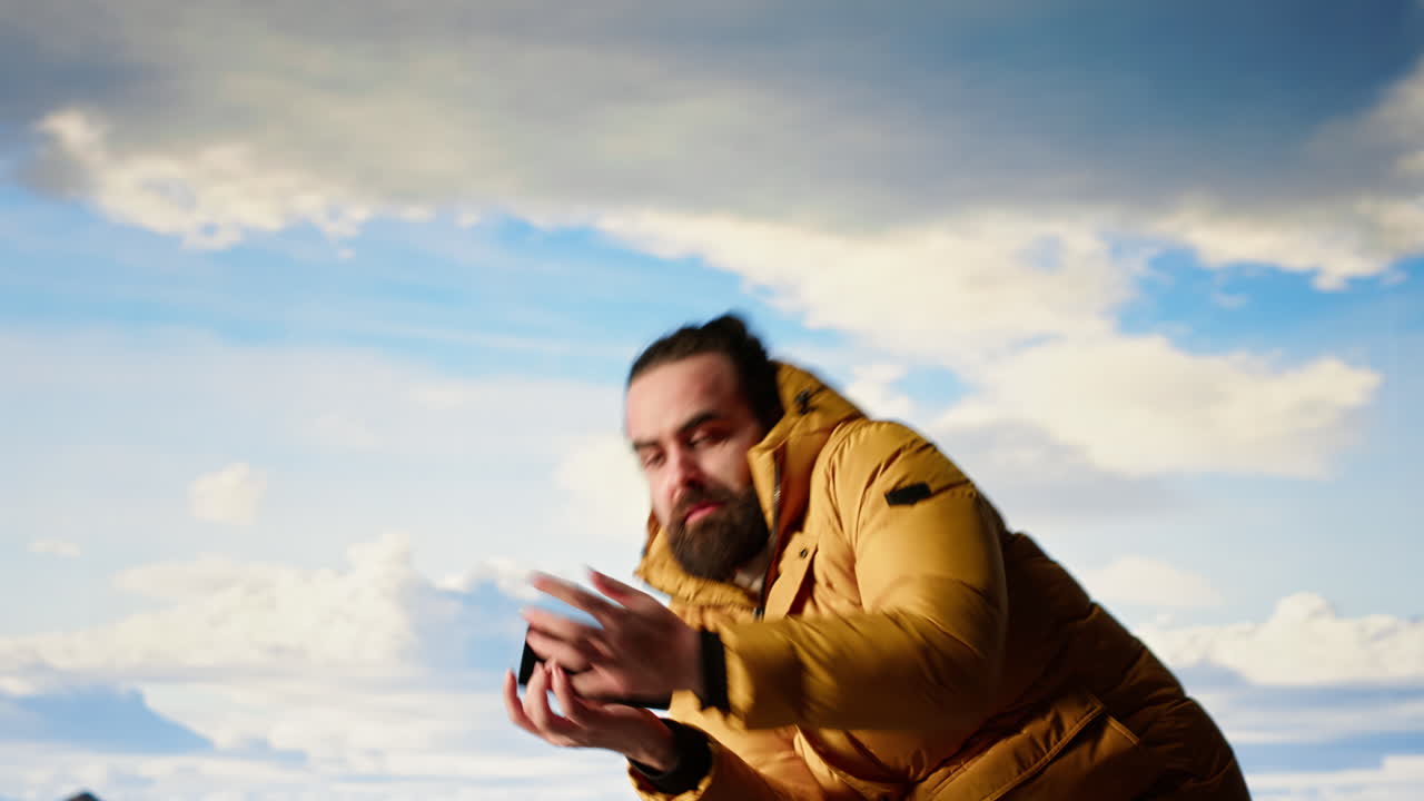 Reckless adventurer losing balance to take a picture and dropping phone