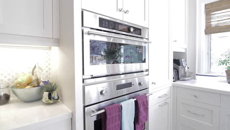 stainless steel oven in a modern white kitchen