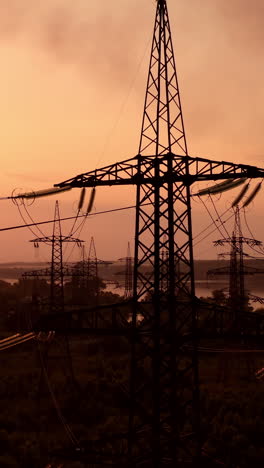 technogenic landscape, urban. the energy of the pole in the rays of the rising sun. posts for the transfer of high lead. steel electric pillars concept. vertical video