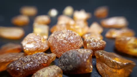 natural baltic amber stones on a black background