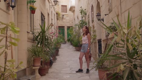 woman exploring a charming narrow street in a mediterranean city