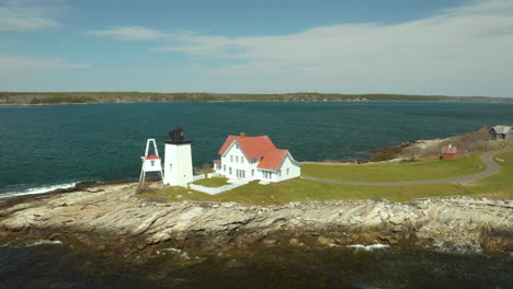 scenic orbiting aerial of hendrick's head lighthouse in southport, maine usa